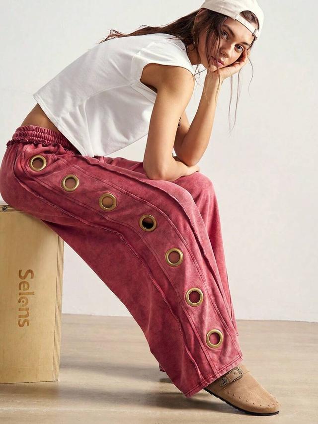 red knit wide leg sweatpants with metal grommet detailing