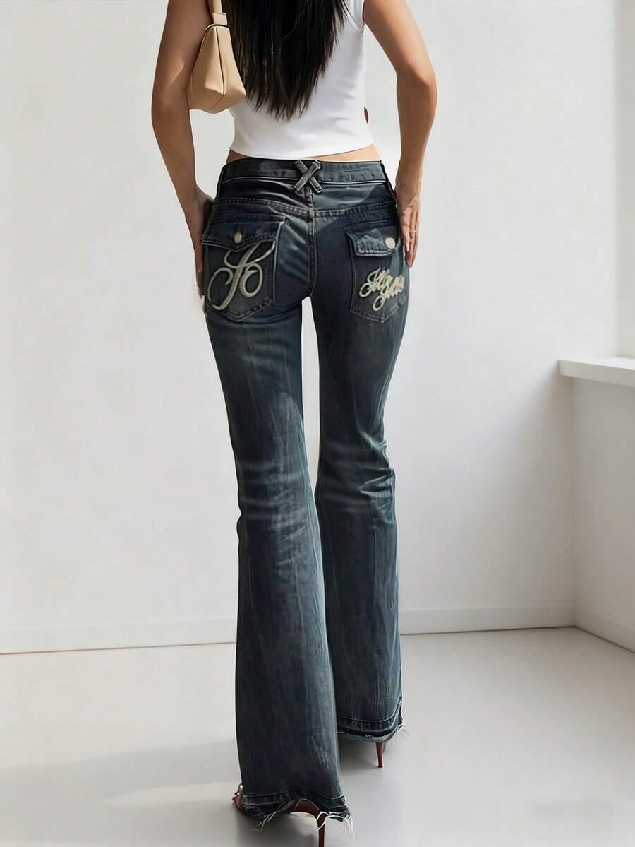 embroidered low rise flare jeans with tie dye details