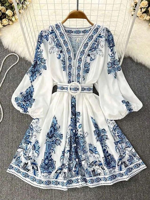 blue and white printed long sleeve belted dress
