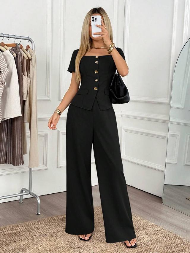 black short sleeve button-up top and wide leg trousers