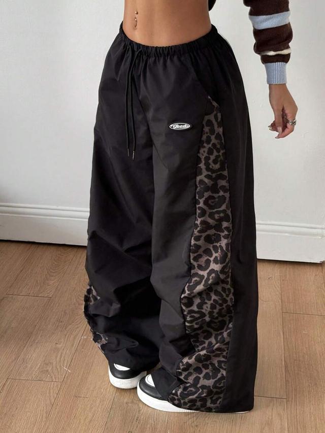 black baggy parachute pants with leopard patchwork