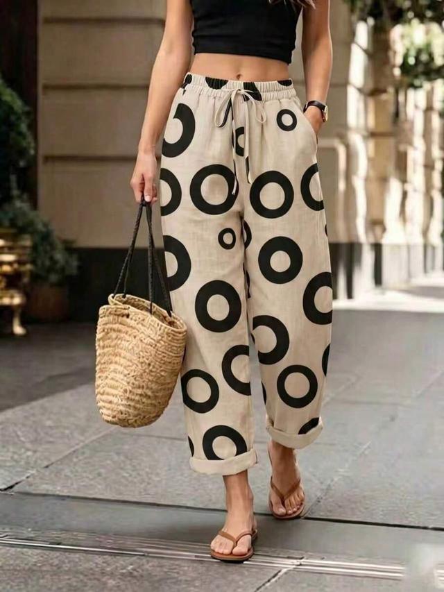 beige and black circle print drawstring trousers