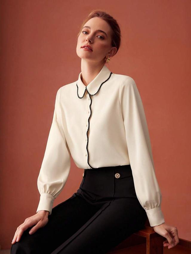 cream long sleeve blouse with contrast black trim