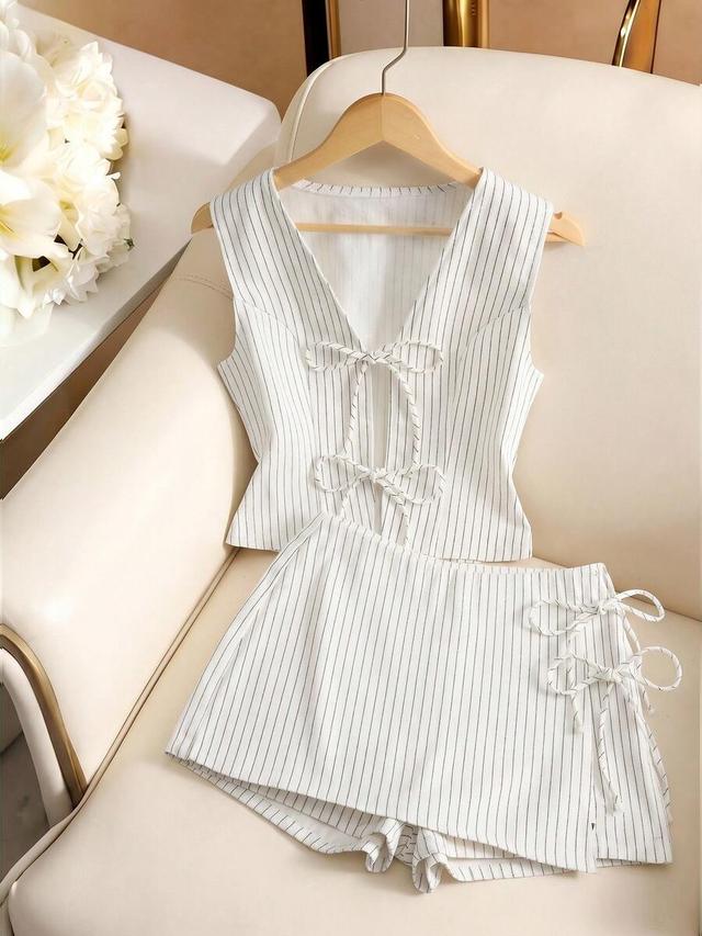 white pinstriped sleeveless vest with matching side-tie skort