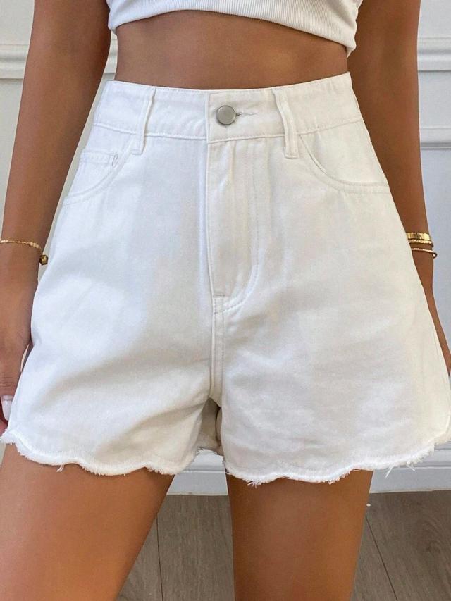 high-waisted white denim shorts with raw hem