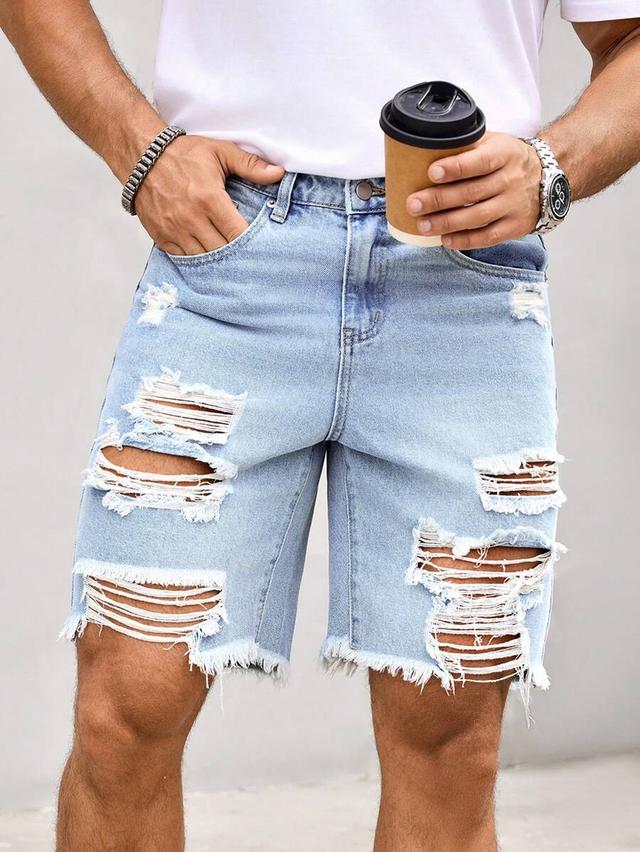 light wash distressed denim shorts with raw hem