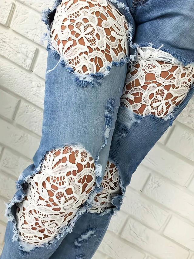 distressed light wash denim jeans with white lace inserts
