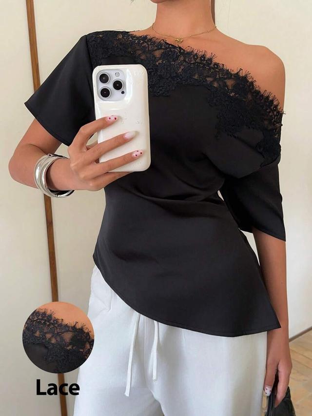 elegant black satin top with asymmetrical lace trim