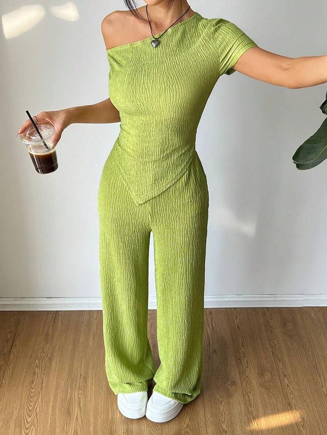 lime green asymmetrical shoulder top and wide leg pants