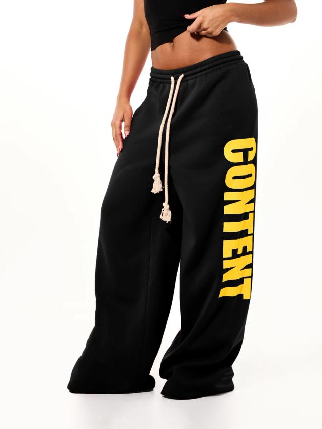 black wide leg fleece joggers with yellow letter print