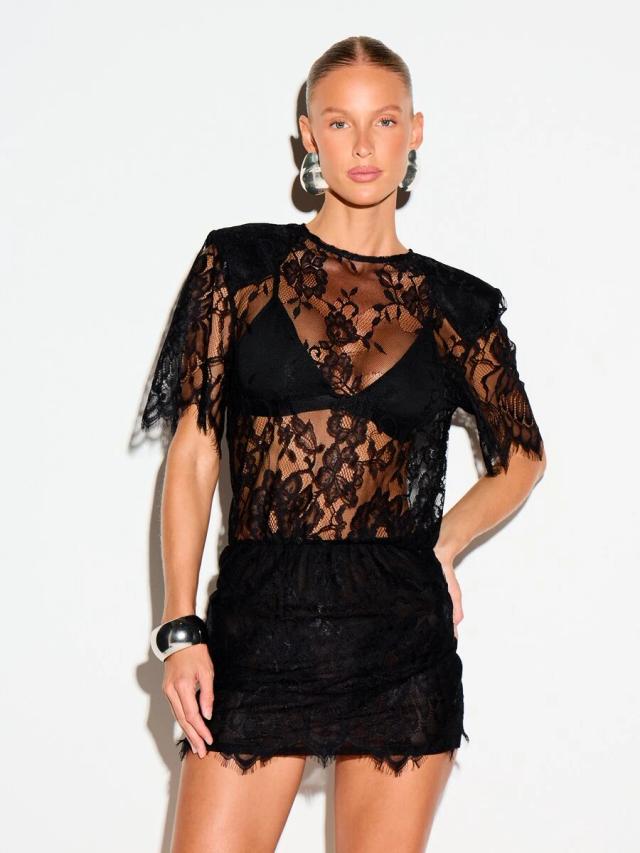 black lace mini dress with shoulder pads and sheer overlay
