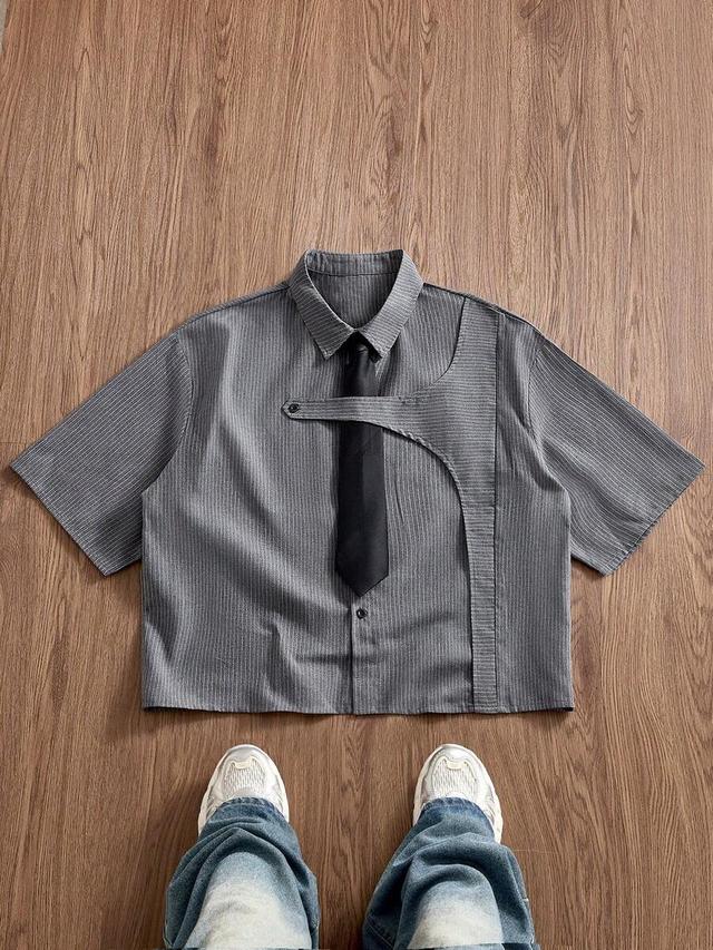 grey pinstripe short-sleeved shirt with asymmetric cutout detail