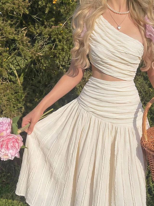 textured white one shoulder crop top and ruffled skirt