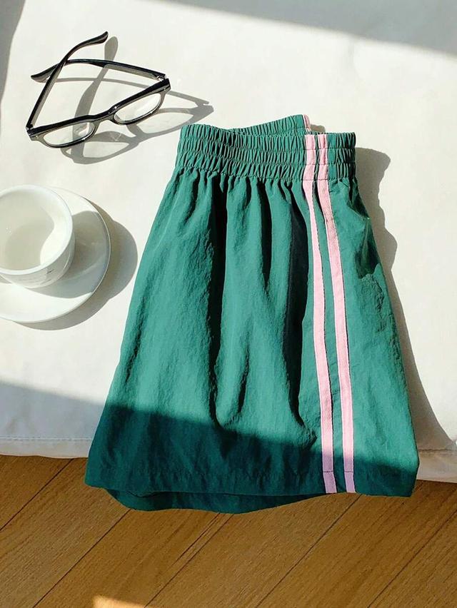 green athletic shorts with pink side stripe