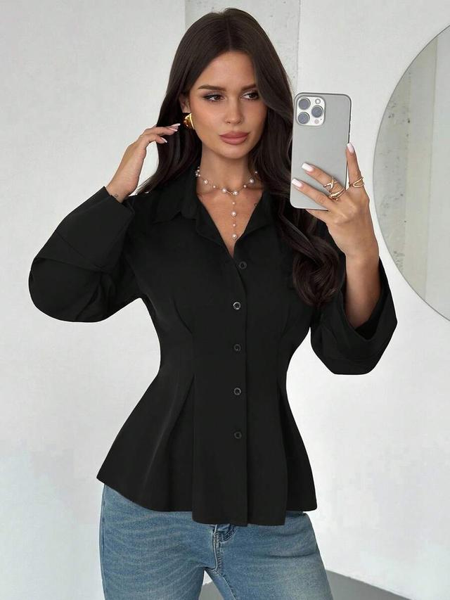 elegant black waist-cinched long-sleeved shirt