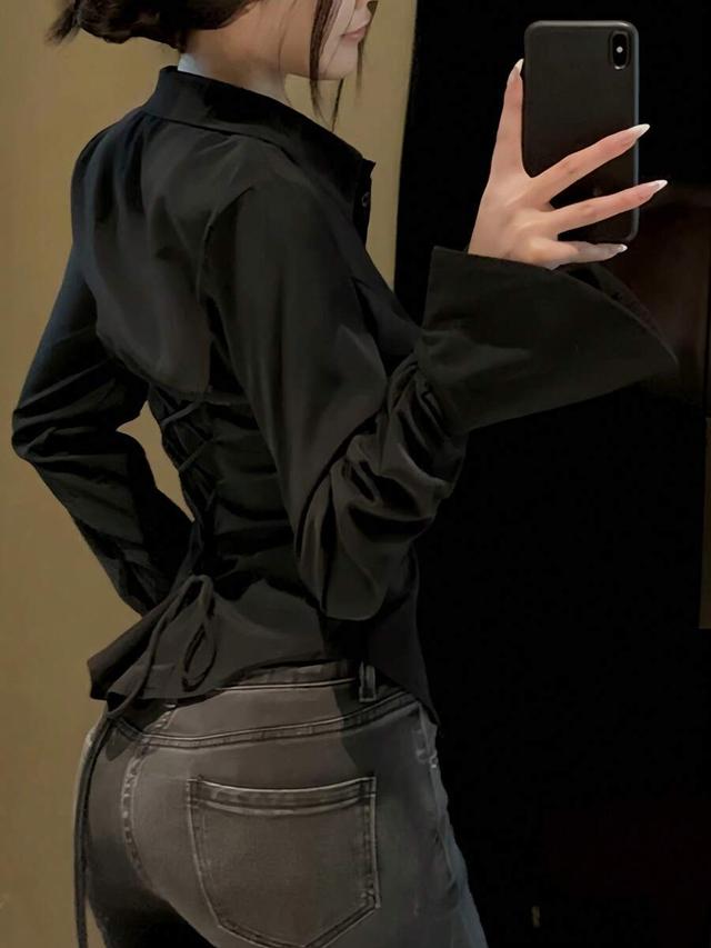 elegant black shirt with back tie and button details