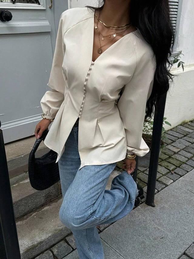 elegant solid color waist cinching button-up shirt