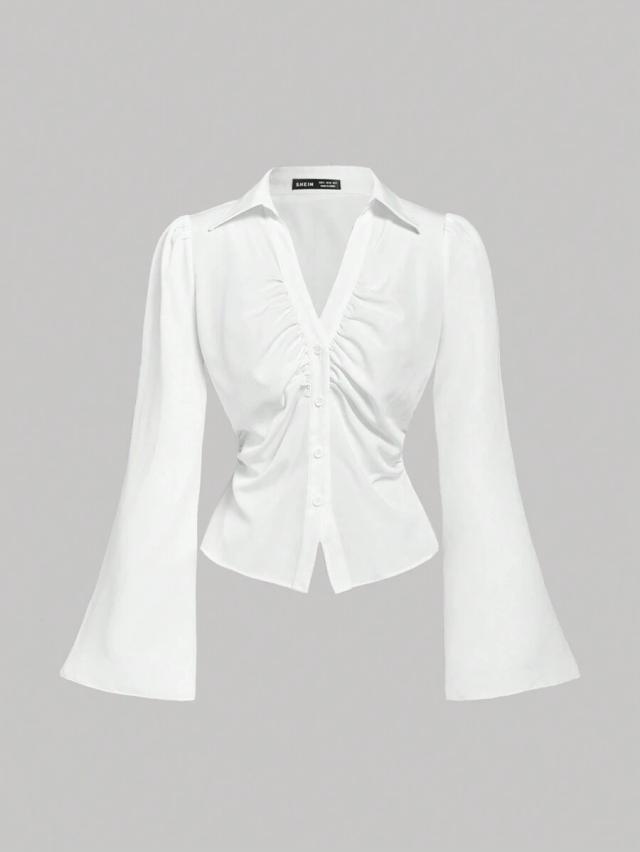 white v-neck button down blouse with flared sleeves