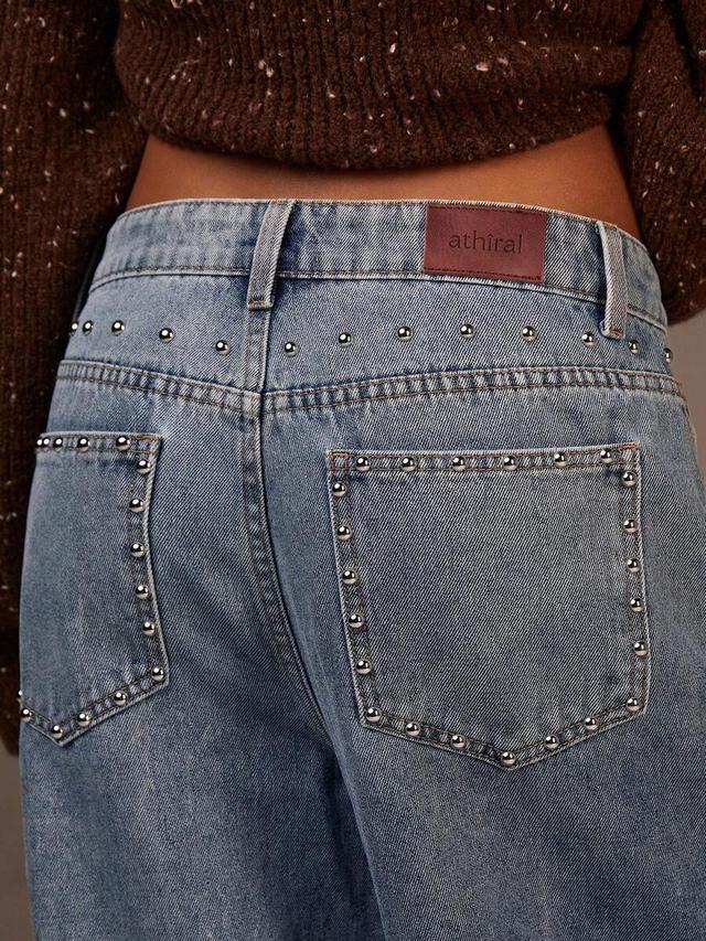 light wash blue wide-leg denim jeans with rivet details