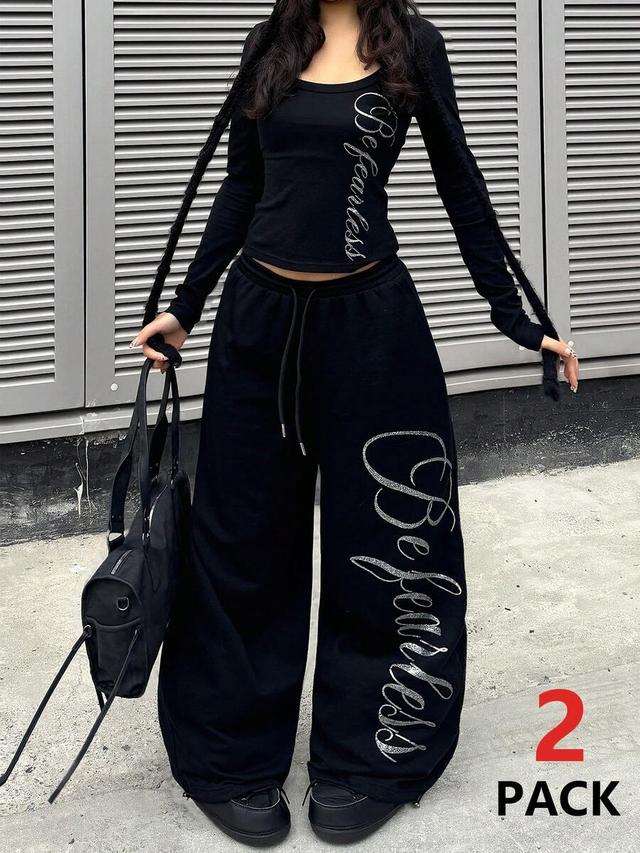 black wide leg sweatpants with silver graphic print