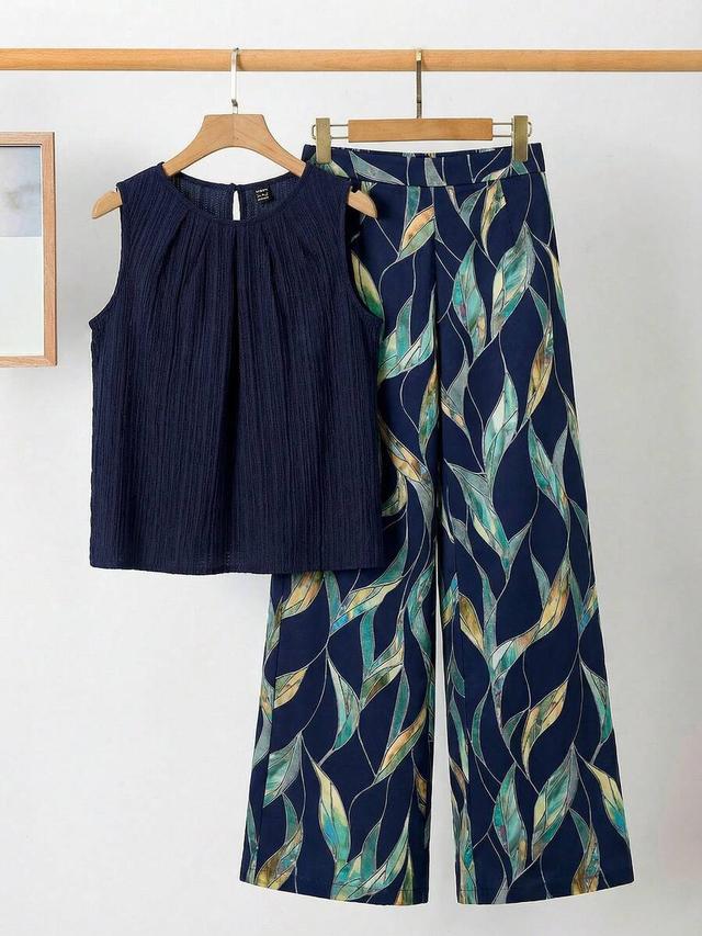 navy pleated sleeveless blouse and floral wide leg pants
