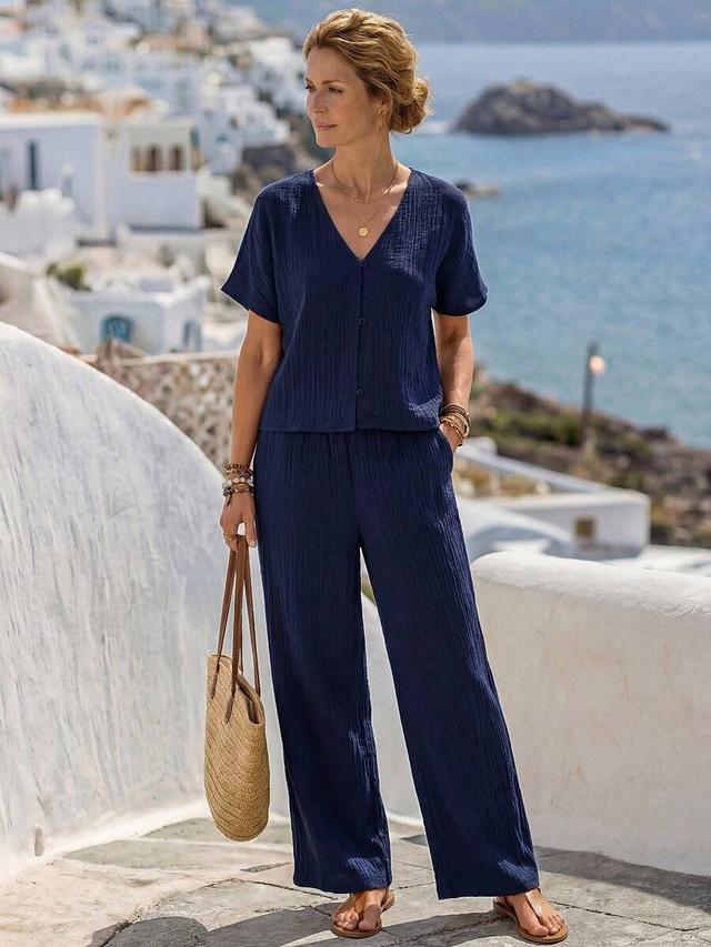 navy blue textured button-up shirt and wide-leg trousers