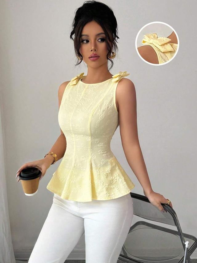 yellow floral textured woven peplum top with bow straps