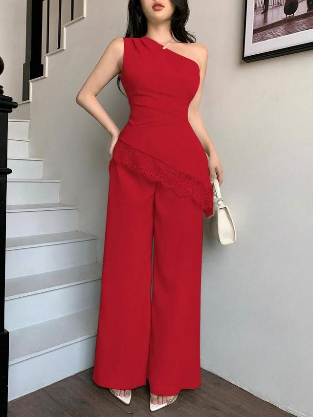 red one-shoulder sleeveless top with wide-leg trousers