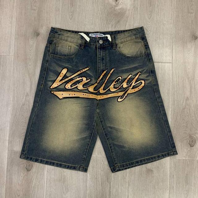 distressed denim jorts with rhinestone graphic lettering