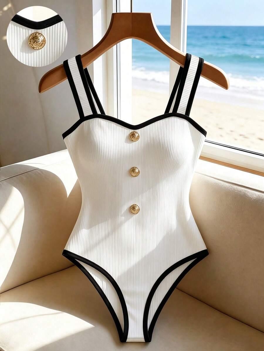white ribbed bodysuit with black trim and gold buttons
