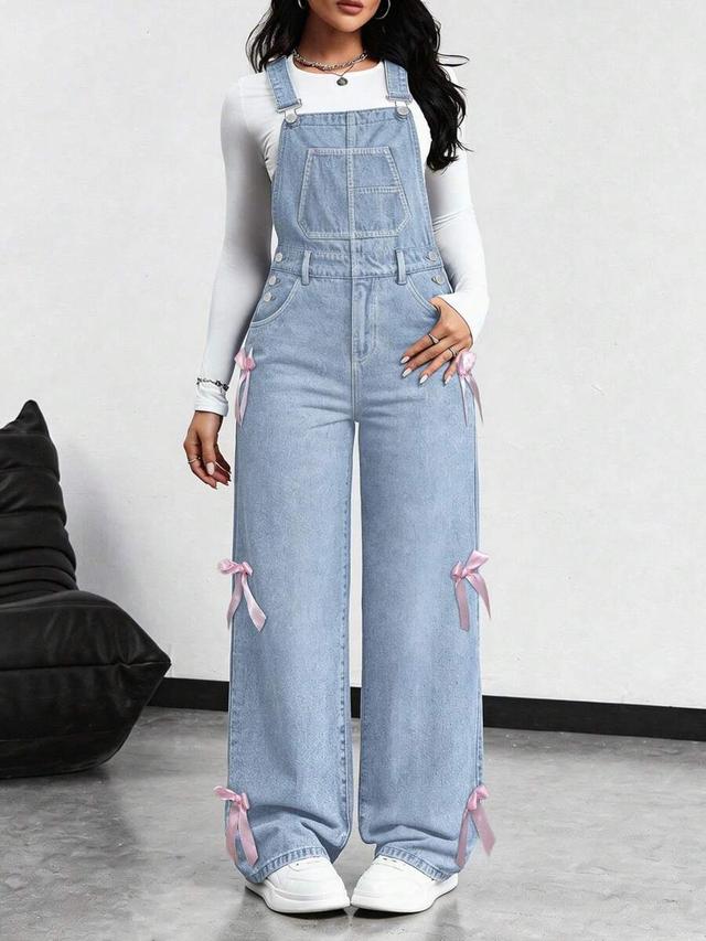 light wash denim overall with pink ribbon detail