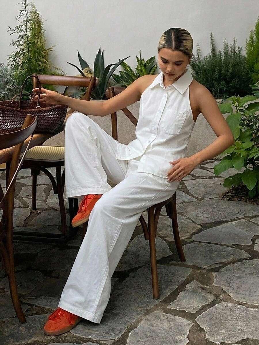 white sleeveless denim vest and wide leg denim trousers