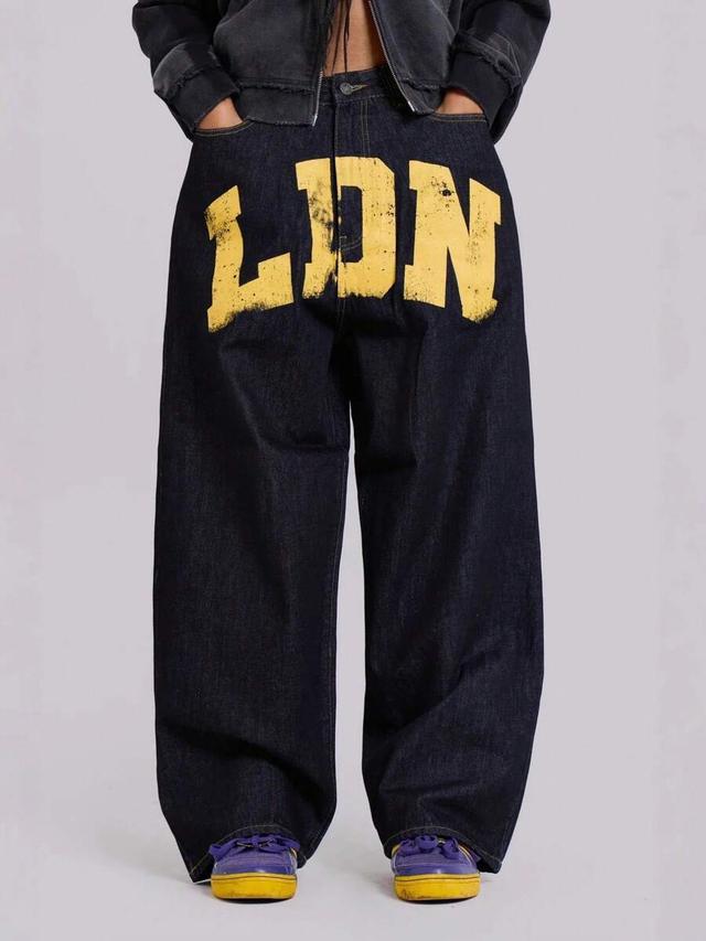 dark wash denim jeans with yellow graphic print