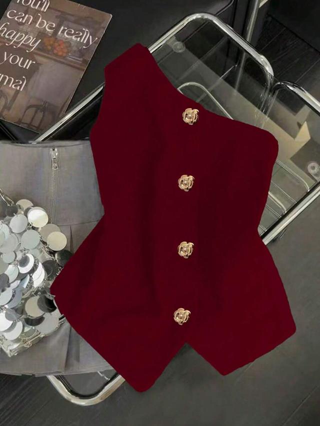 burgundy one-shoulder blouse with decorative gold metal buttons