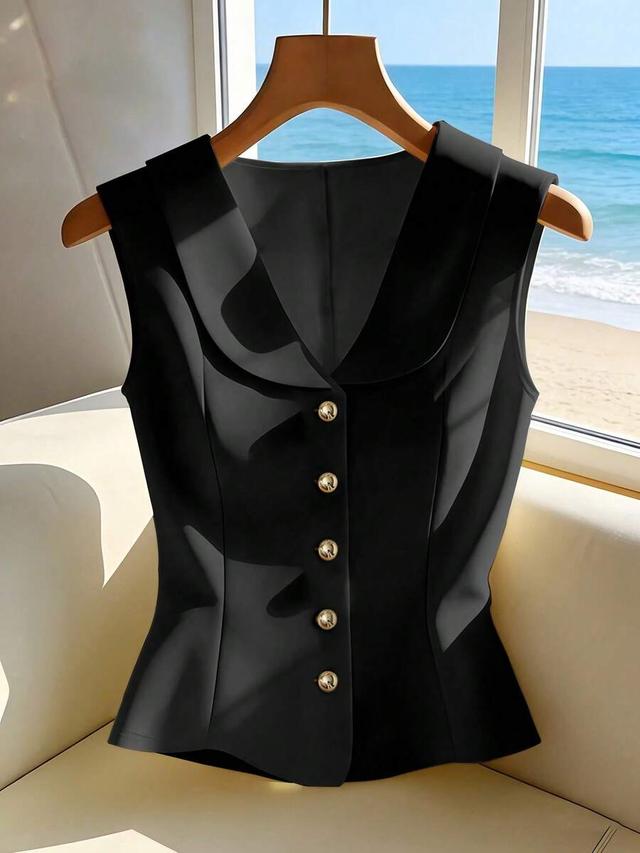 elegant sleeveless black tailored blouse with gold buttons