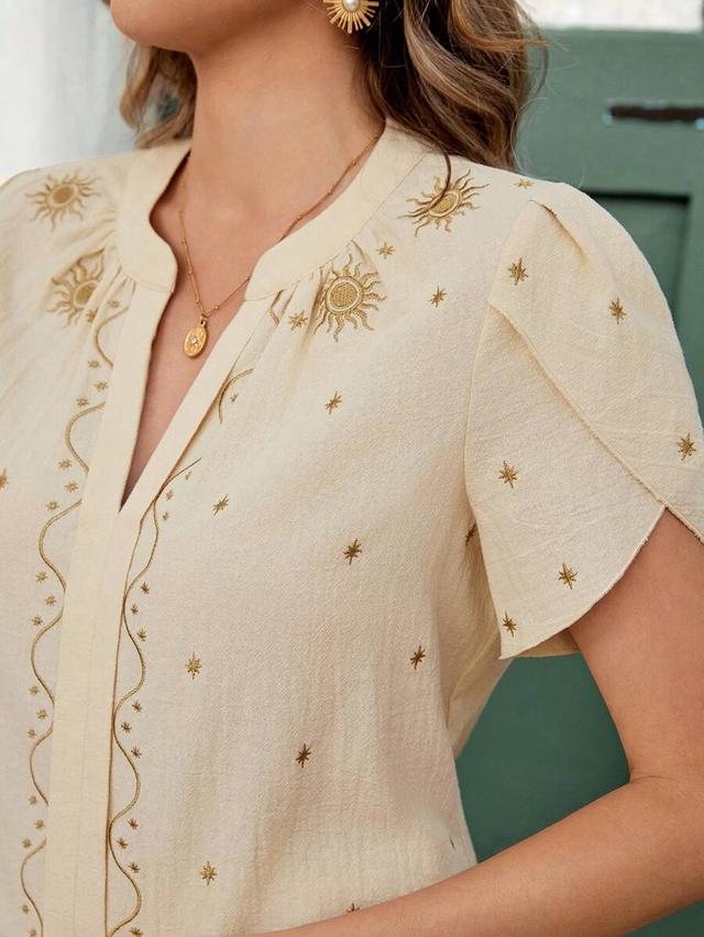 beige notch neck blouse with floral sun embroidery