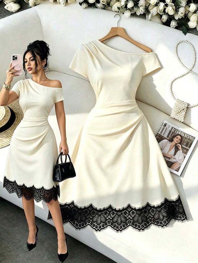 off-shoulder cream dress with black lace hem