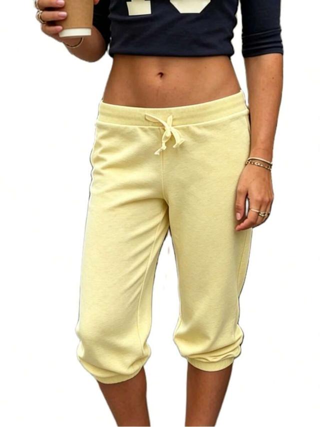 women solid yellow drawstring capri jogger pants