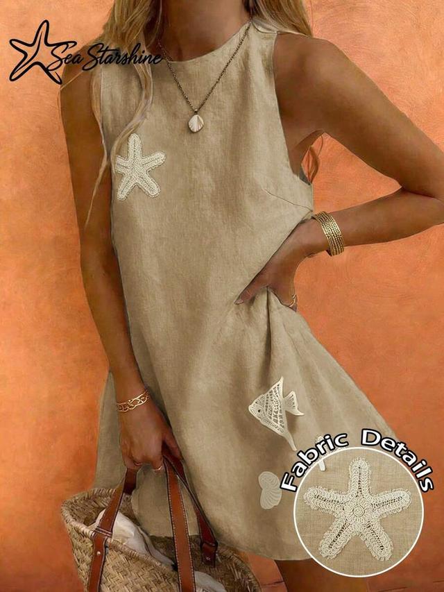 beige linen shift dress with embroidered sea motifs