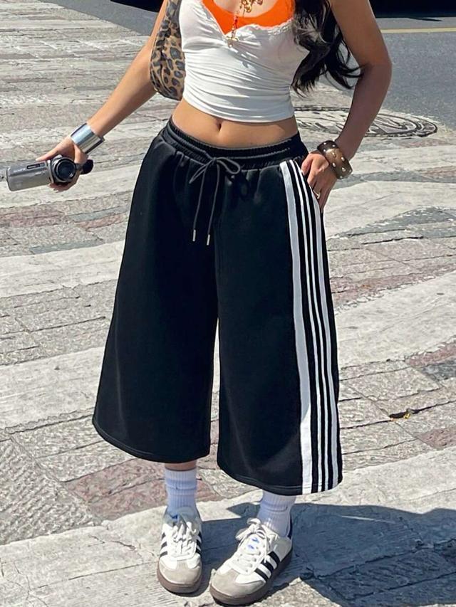 black baggy bermuda shorts with side stripe detail