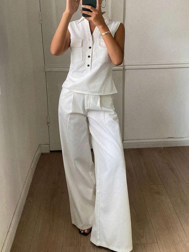 white denim sleeveless collared shirt and loose pants
