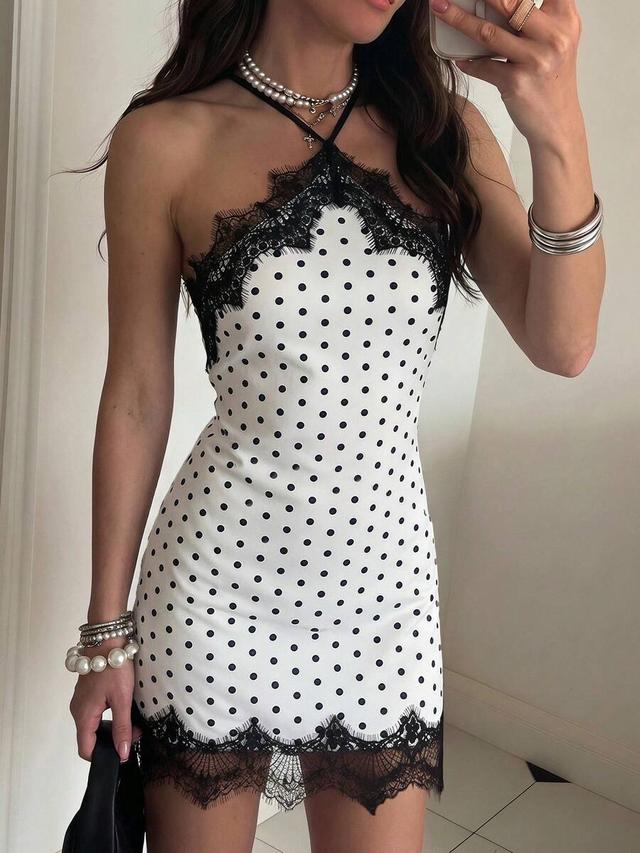 white satin mini dress with black polka dots and lace