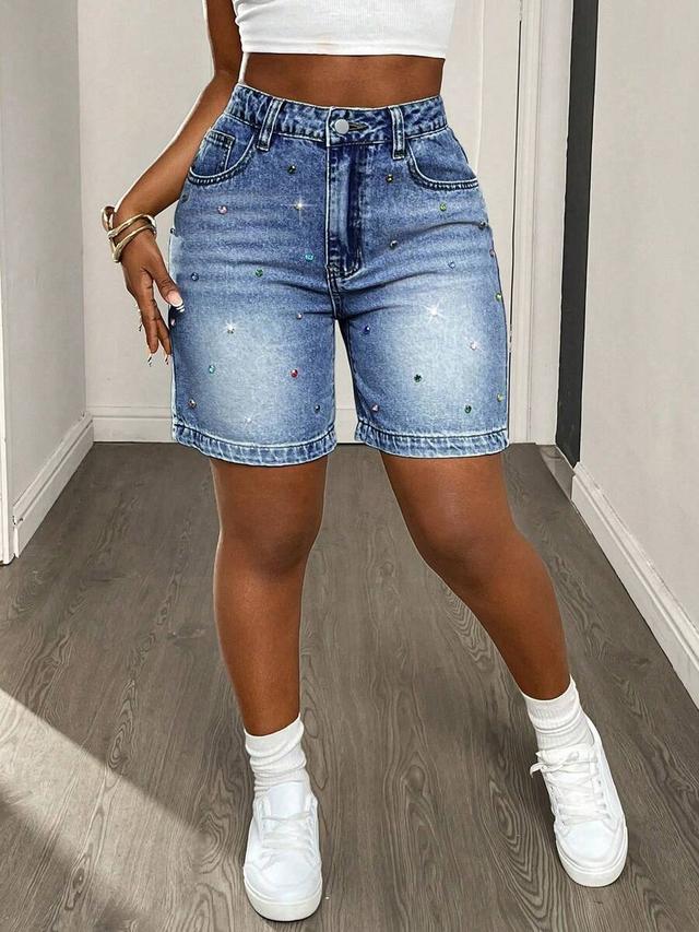 high-waisted medium wash denim shorts with scattered rhinestones