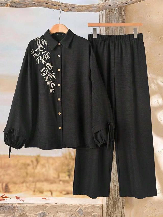 black floral embroidered button-up shirt