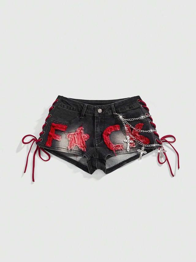 distressed black denim shorts with red lace-up sides