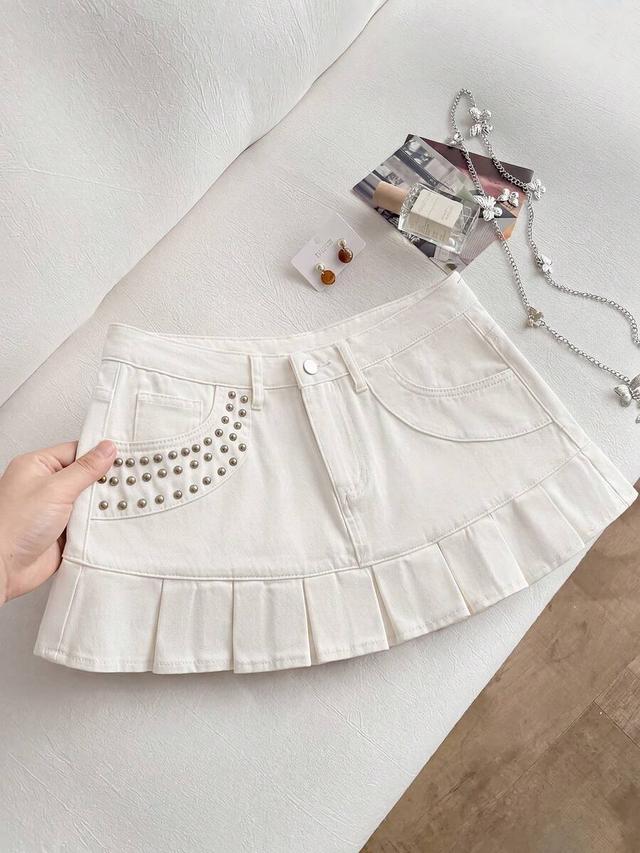 white denim mini skirt with rivet detail and ruffle hem