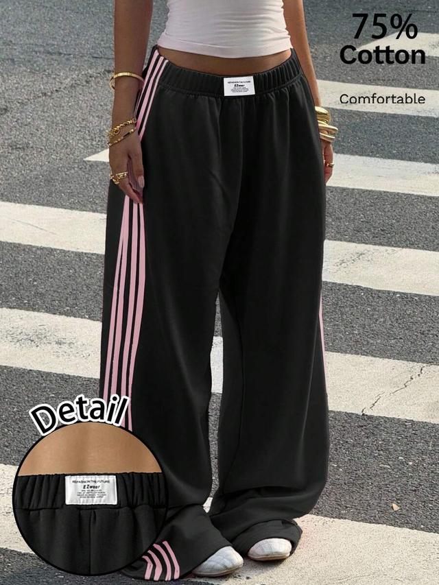 black straight leg sweatpants with pink side stripes