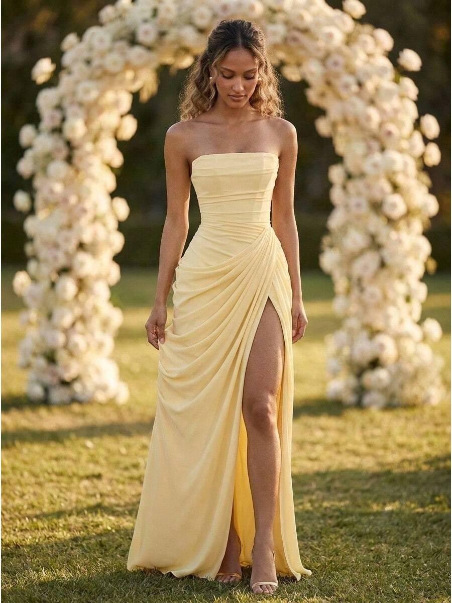 pale yellow strapless draped evening gown with slit