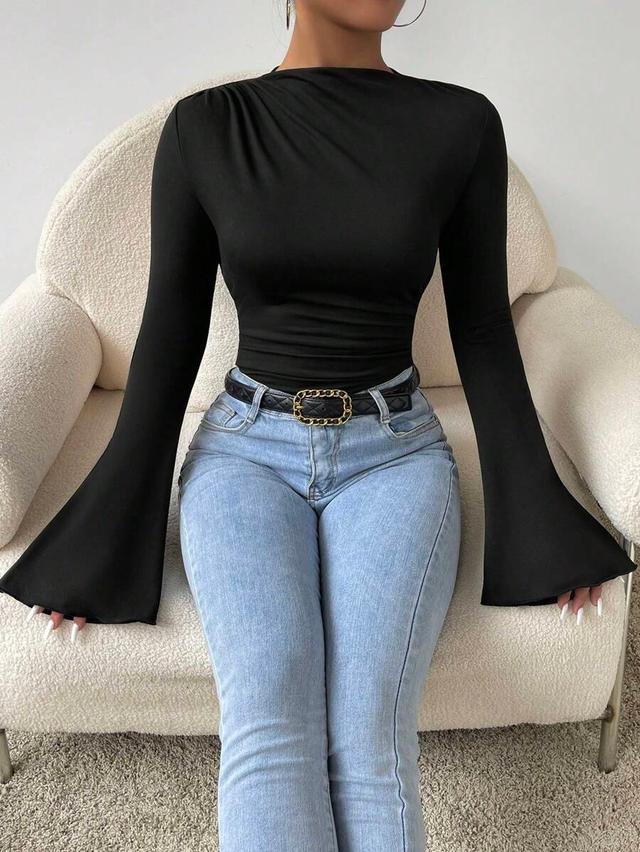black long sleeve top with flared sleeves