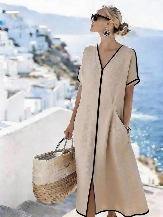 beige linen v-neck dress with black contrast trim